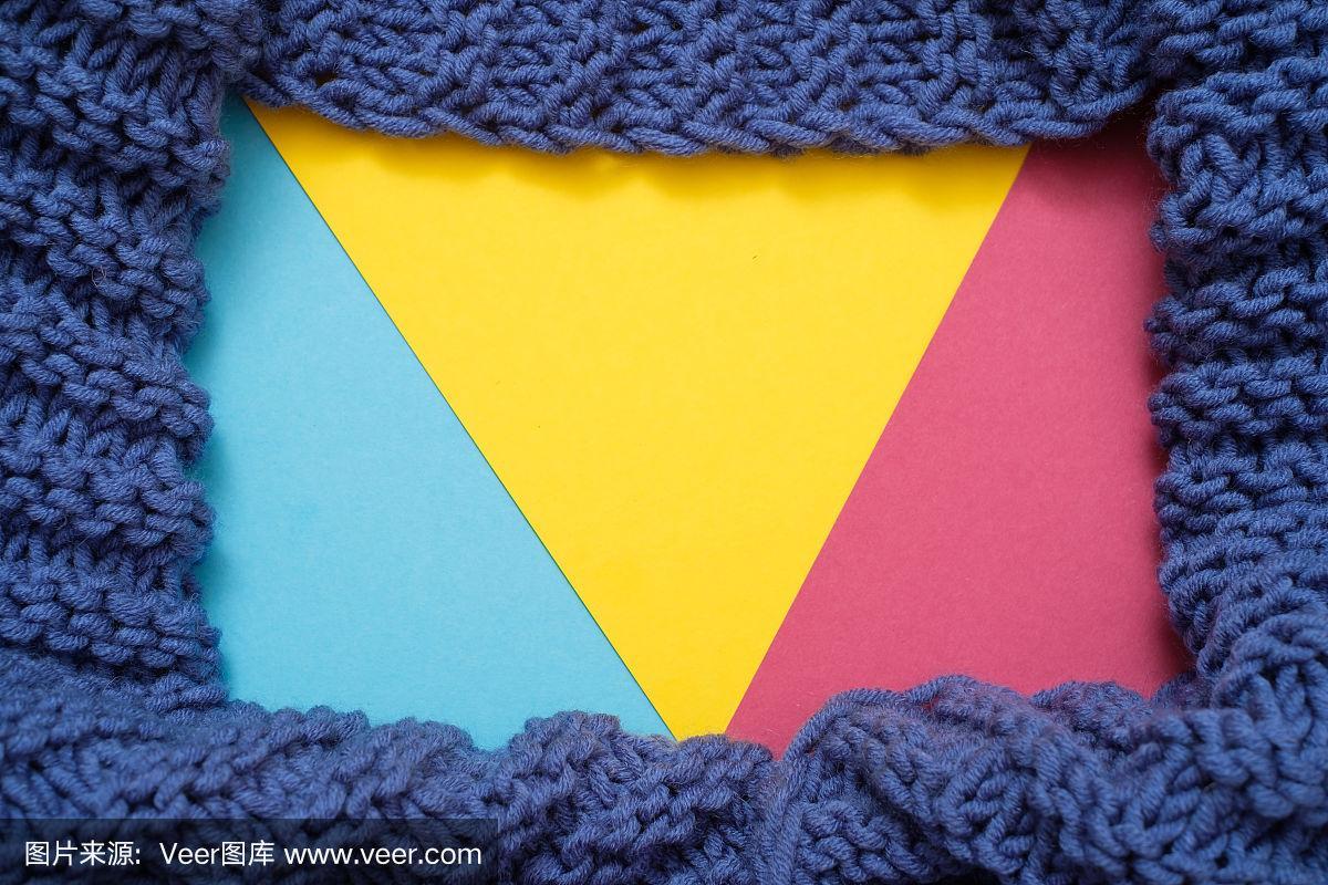 彩色的蓝色,黄色,粉红色的背景与羊毛针织纺织品的背景